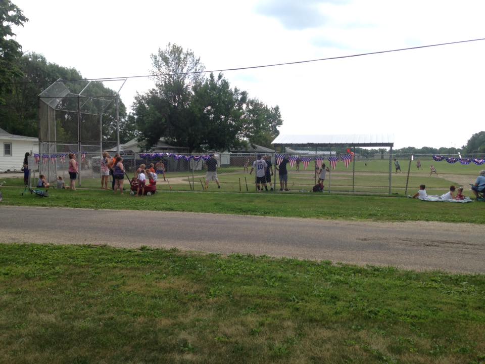 People enjoying a game of baseball on 4th of July